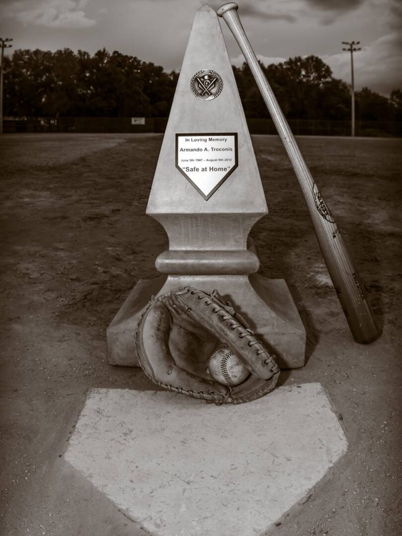 A baseball bat and glove on the ground.